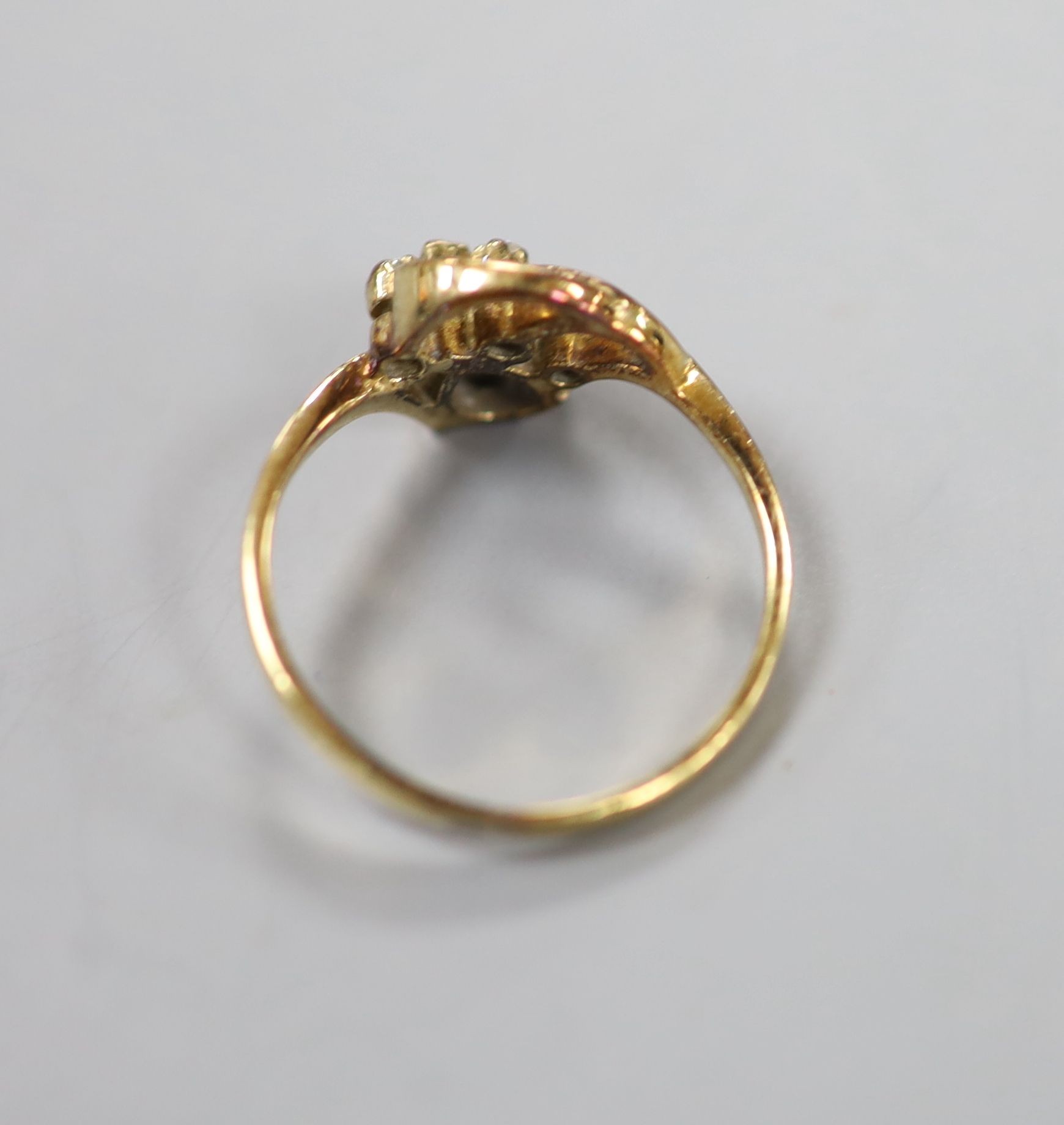 A yellow metal, pear cut sapphire and three stone diamond chip set ring, size J, gross 1.8 grams.